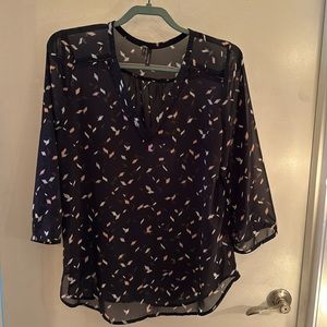 Sheer black 3/4 blouse with pink and white accents and cutouts around neck